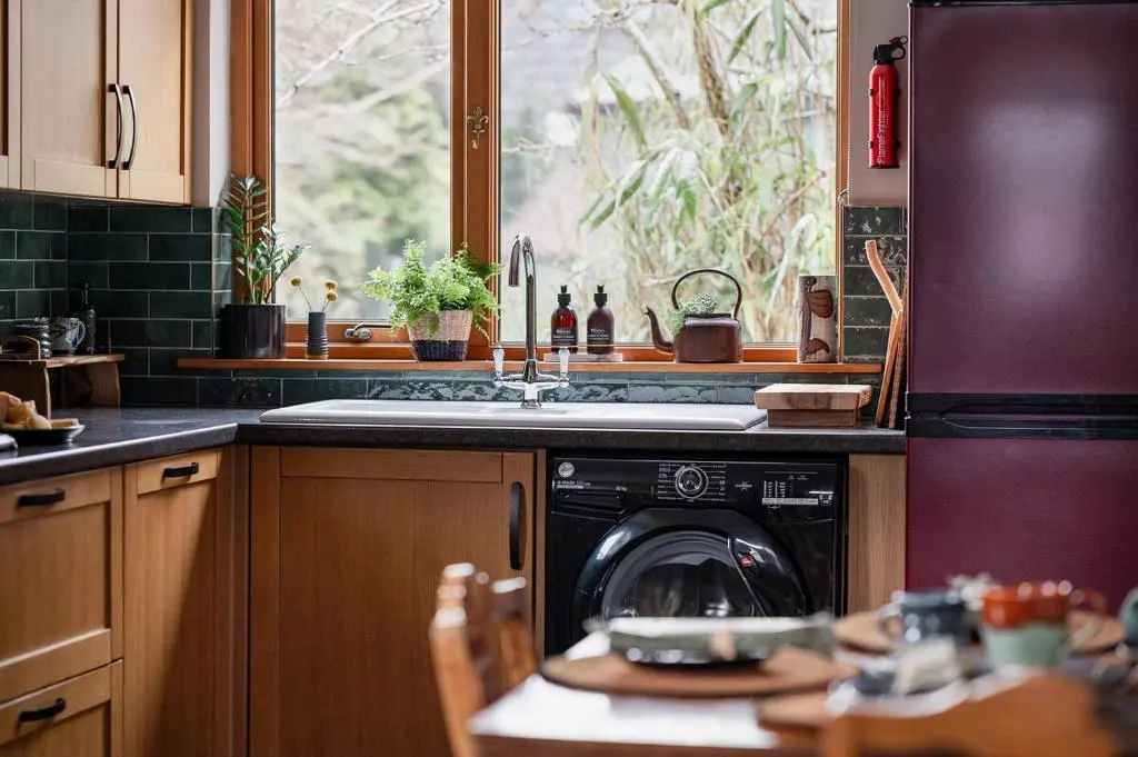 a kitchen with a dishwasher and a sink and a window at Luxury 3 Bedroom Cottage - Sleeps 6 in Tomintoul