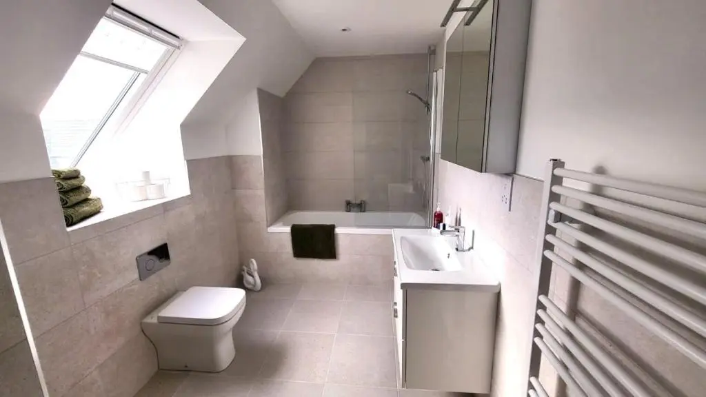 a white bathroom with a toilet and a sink at Insch House in Kincraig