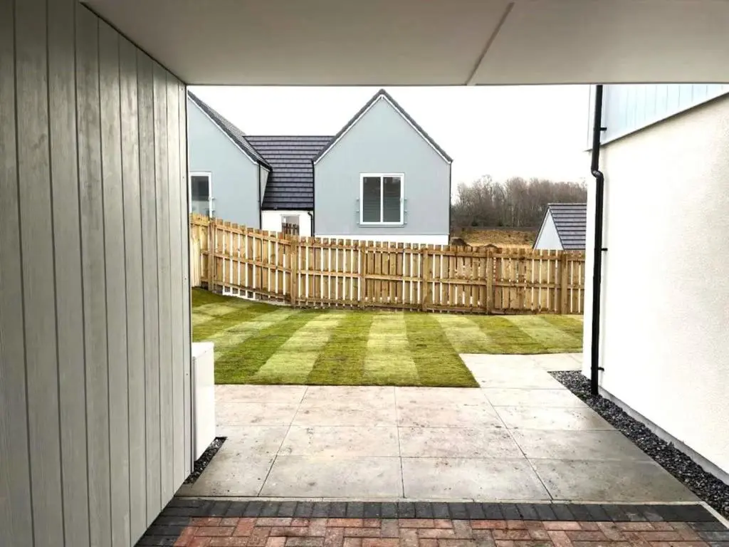 a view of a yard from a house with a fence at Insch House in Kincraig