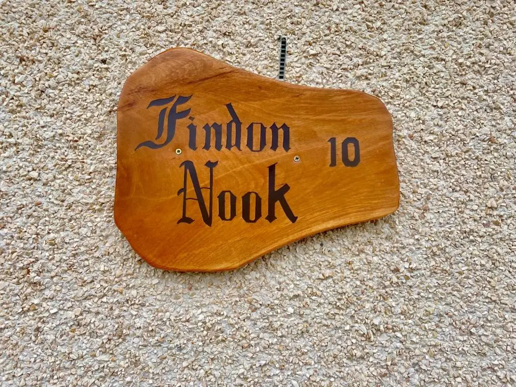 a wooden sign with the words junior mook written on it at Findon nook in Culbokie