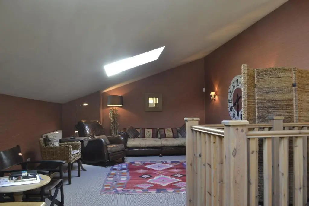 a living room with a couch and a table at Ness Castle Lodges in Inverness
