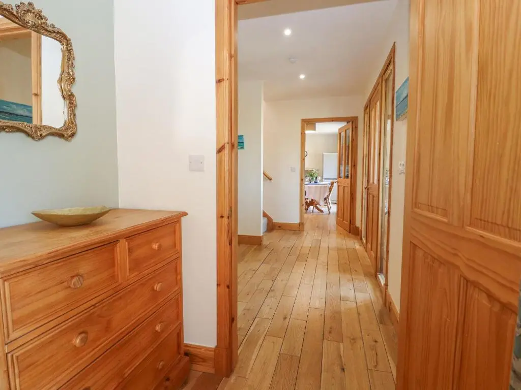 a hallway of a home with a wooden floor at Reyflat Barn in Fortrose
