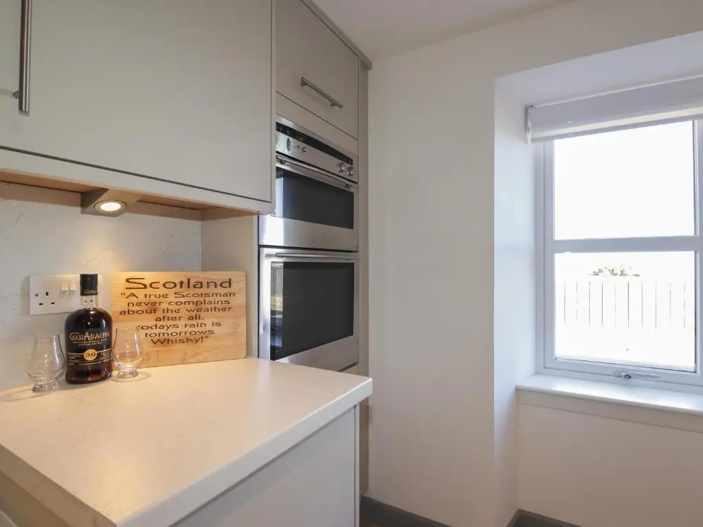 a kitchen with a counter top and a window at The Laurels in Fraserburgh
