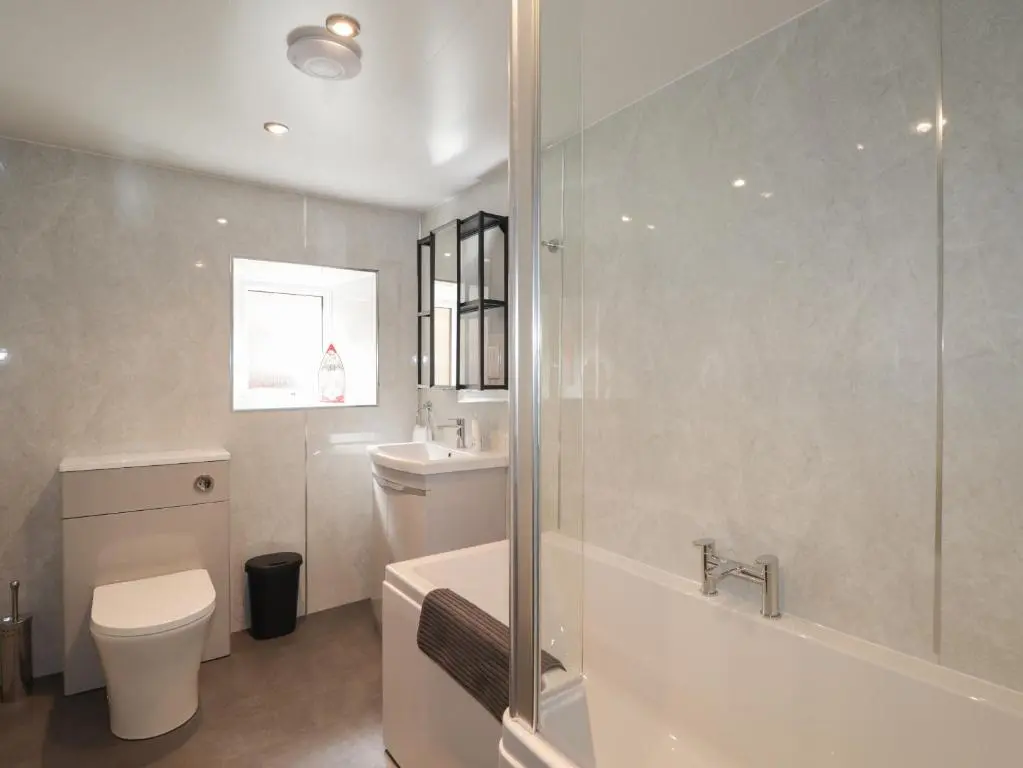 a bathroom with a shower and a toilet and a sink at The Laurels in Fraserburgh