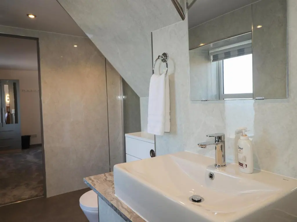 a bathroom with a sink and a toilet and a mirror at The Laurels in Fraserburgh