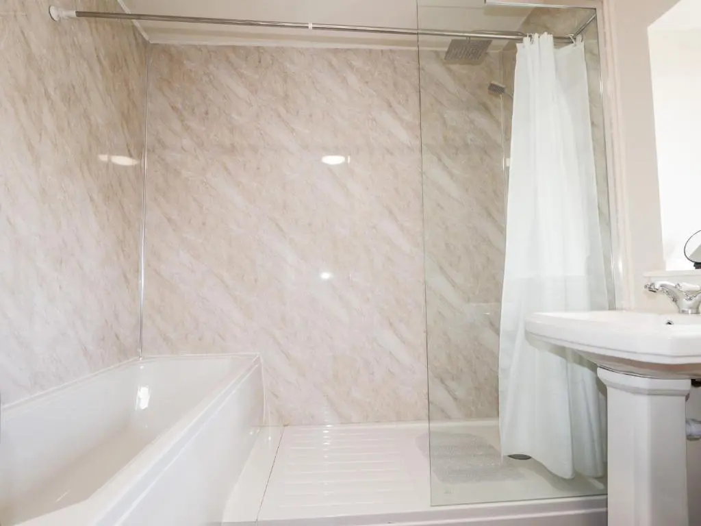 a bathroom with a tub and a sink and a shower at Loubcroy Farm House in Lairg
