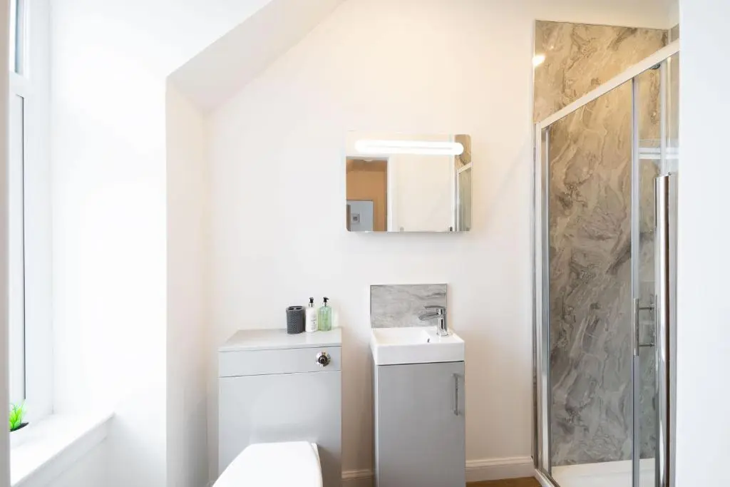 a bathroom with a toilet and a sink and a shower at The Corner House in Hopeman