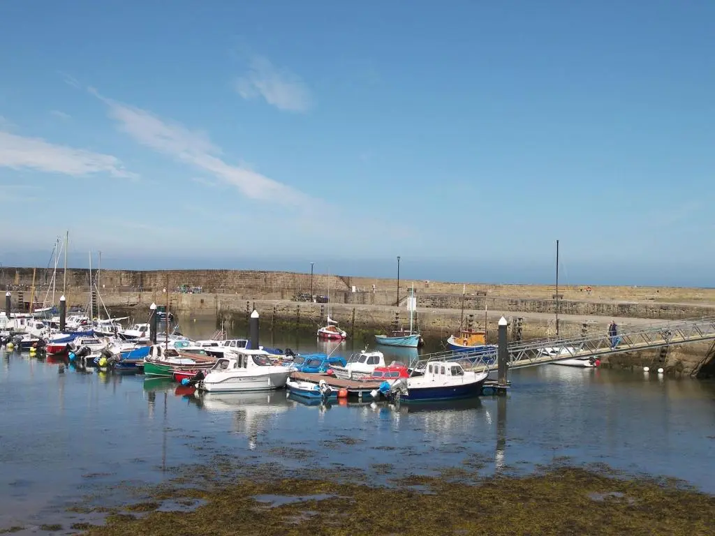 a bunch of boats are docked in a harbor at The Corner House in Hopeman