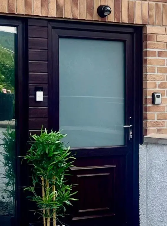 a glass door to a house with a plant at Eldon Lea in Strathpeffer