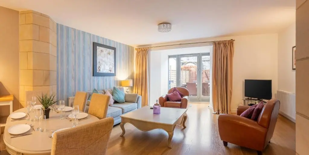 a living room with a couch and a table at Abbey Church 9 The Nave 2 bedroom Luxury Self catering apartment in Historic Abbey in Fort Augustus