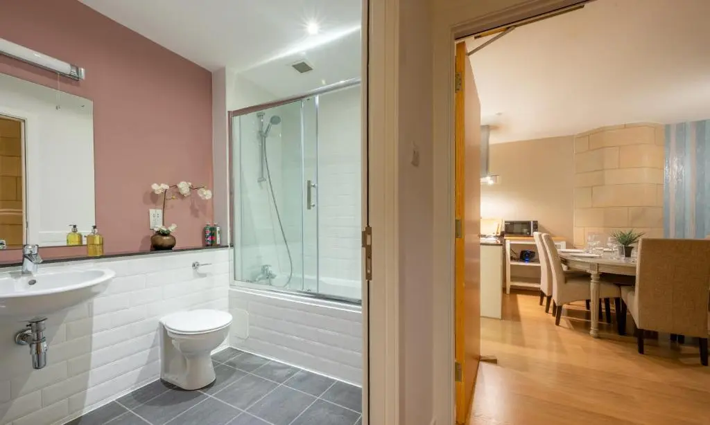 a bathroom with a shower and a toilet and a sink at Abbey Church 9 The Nave 2 bedroom Luxury Self catering apartment in Historic Abbey in Fort Augustus