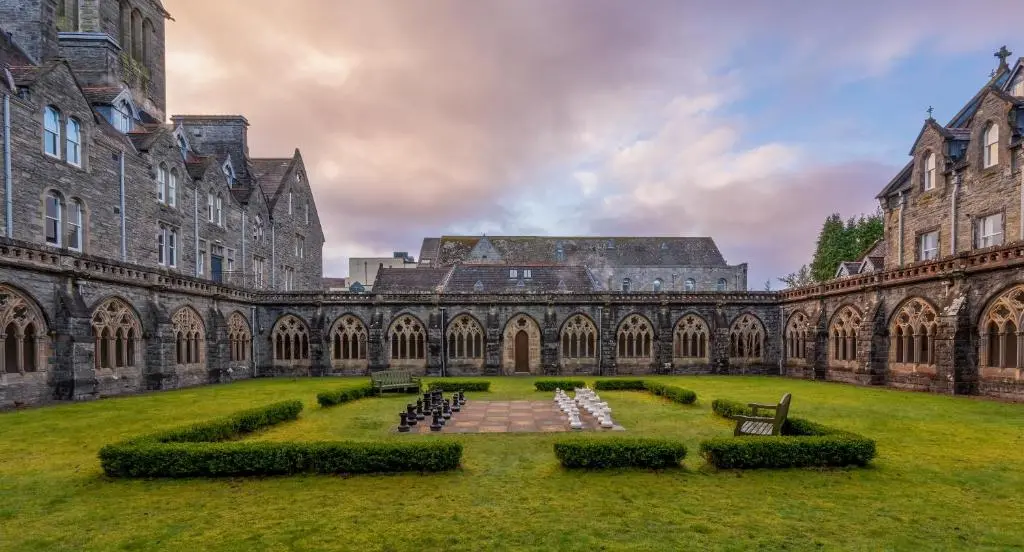 a large building with a yard in front of it at AC19 Lower North Aisle - Luxury Self Catering 2 Bedroom Apartment in Fort Augustus