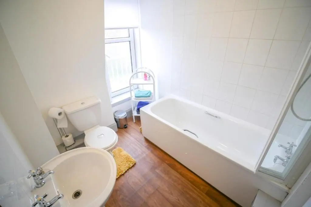 a bathroom with a tub and a toilet and a sink at Telford Rd 5 Bedroom House Inverness in Inverness