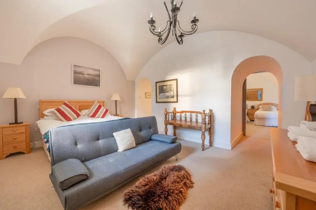 a living room with a couch and a bed at Major's Apartment 3 Bedroom Self Catering Property in historic Abbey in Fort Augustus