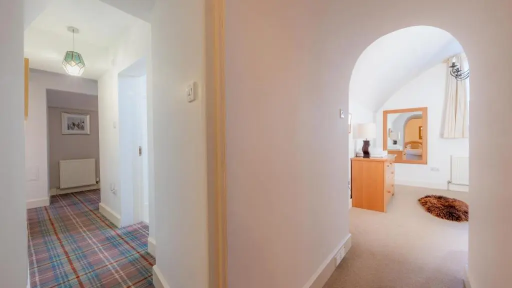 a hallway with an archway in a house at Major's Apartment 3 Bedroom Self Catering Property in historic Abbey in Fort Augustus