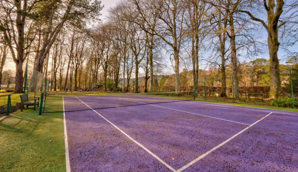 a purple tennis court with a bench on it at Major's Apartment 3 Bedroom Self Catering Property in historic Abbey in Fort Augustus