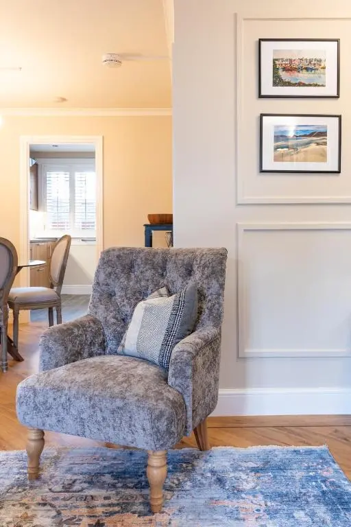 a living room with a chair and a couch at Apartment 91 in Inverness