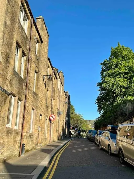 a street with cars parked on the side of a building at Bed on the Brae in Inverness