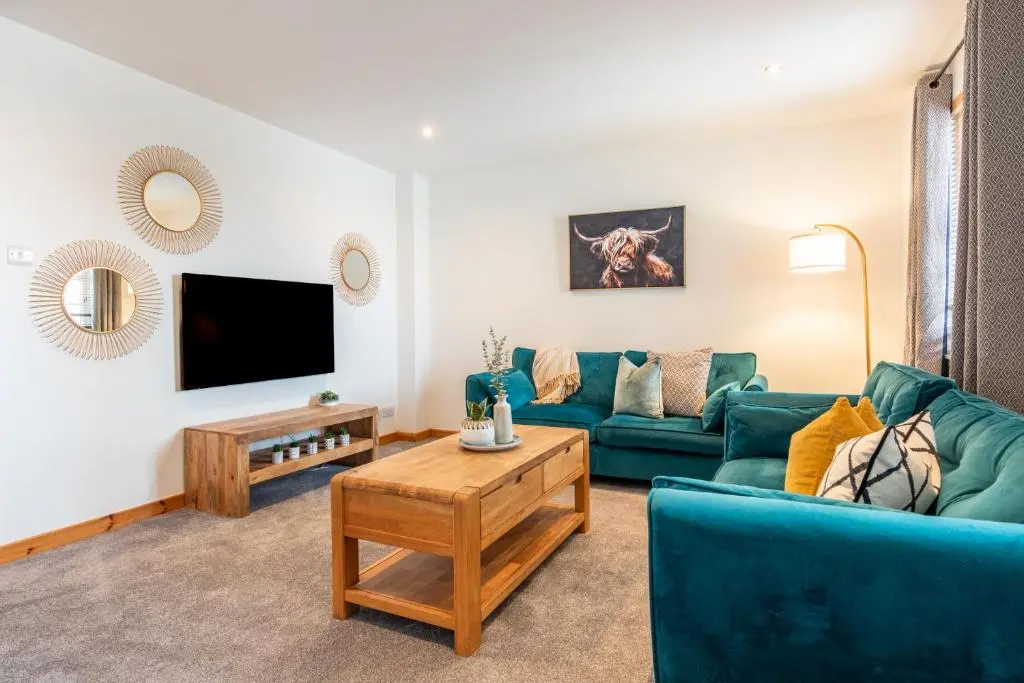 a living room with a couch and a tv at Ness Station in Inverness