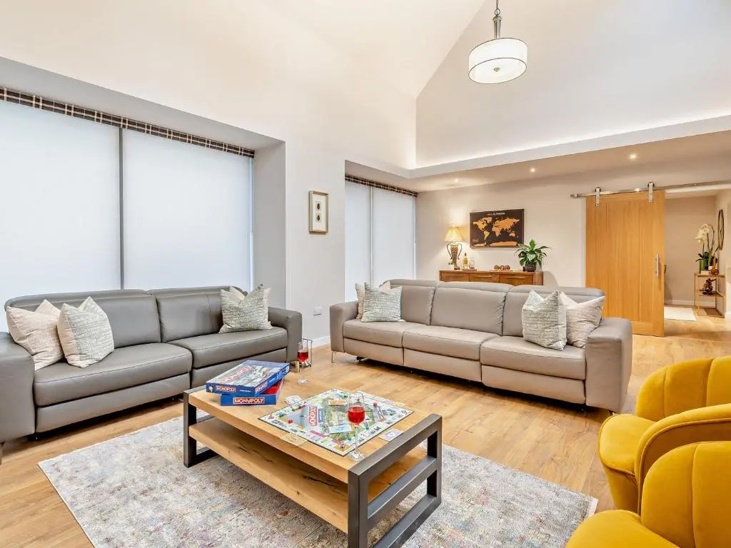 a living room with two couches and a coffee table at 4 Bed in Dyce 93914 in Dyce