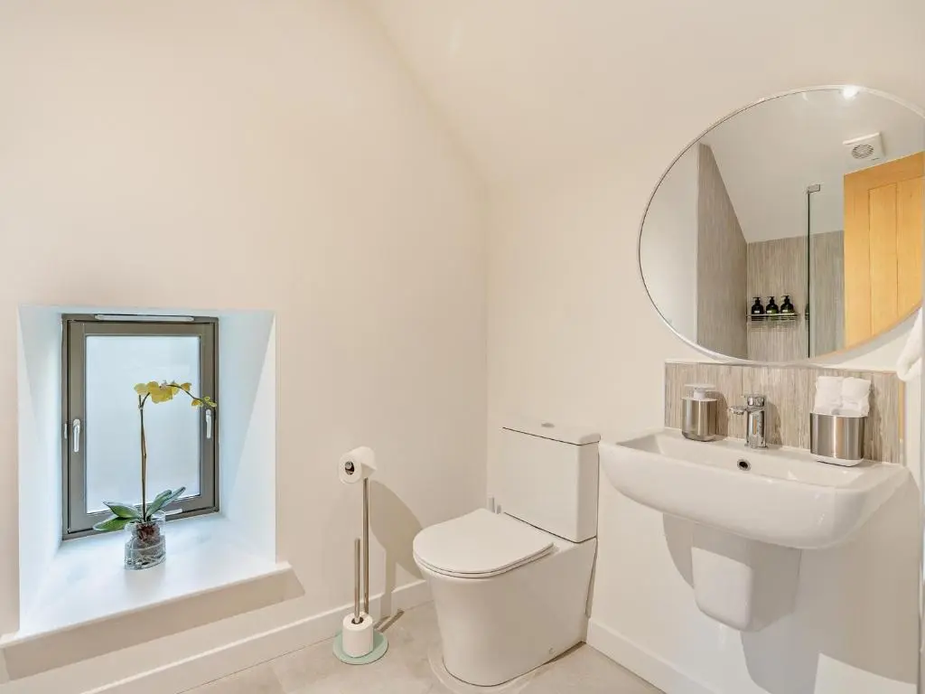 a white bathroom with a toilet and a sink at 4 Bed in Dyce 93914 in Dyce