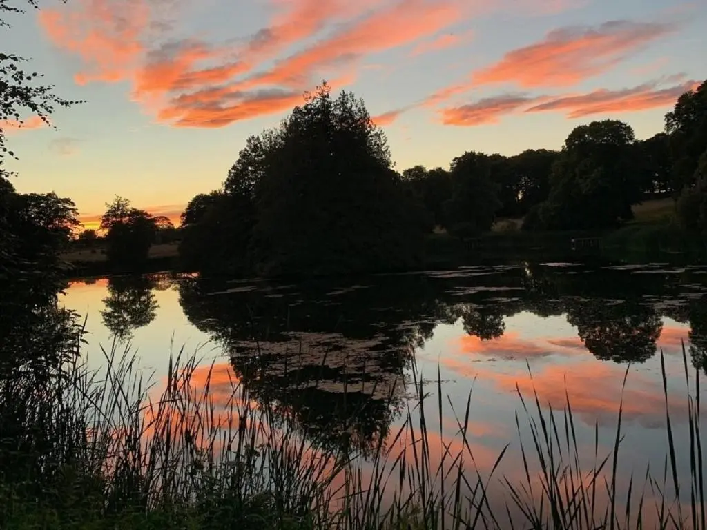 a view of a lake at sunset at 4 Bed in Dyce 93914 in Dyce