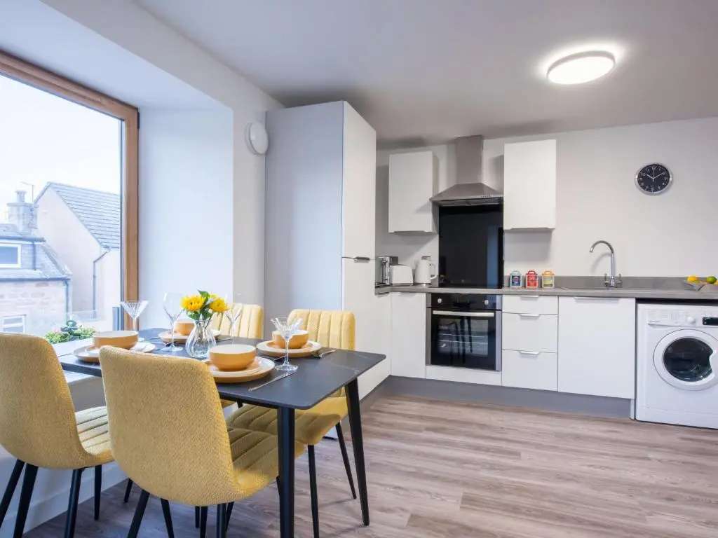 a kitchen and dining room with a table and chairs at Apartment Harbour Nights Deluxe 7C by Interhome in Lossiemouth