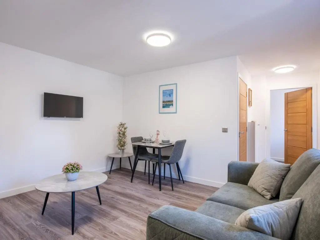 a living room with a couch and a table at Apartment Harbour Nights Deluxe 7B by Interhome in Lossiemouth