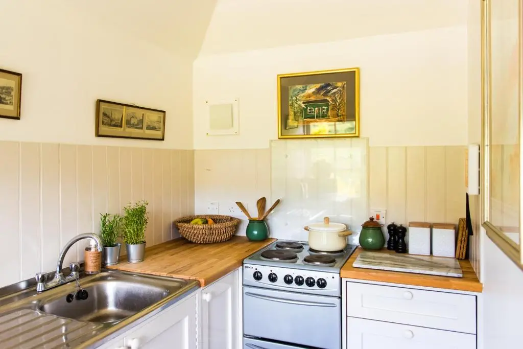 a kitchen with a stove and a sink at Colmeallie Bothy - Seasgair Lodges in Brechin