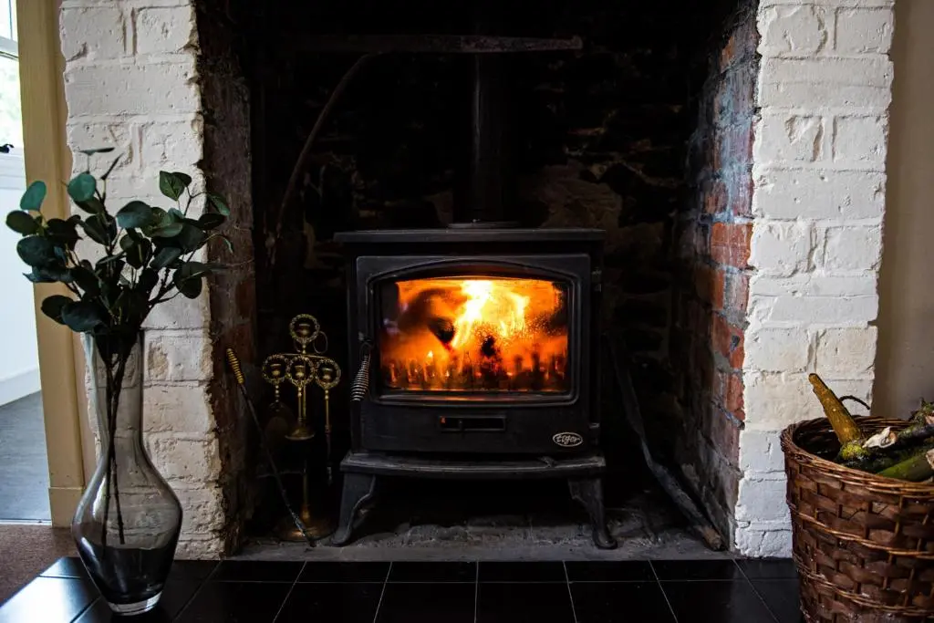 a wood burning stove in a brick fireplace at Colmeallie Bothy - Seasgair Lodges in Brechin