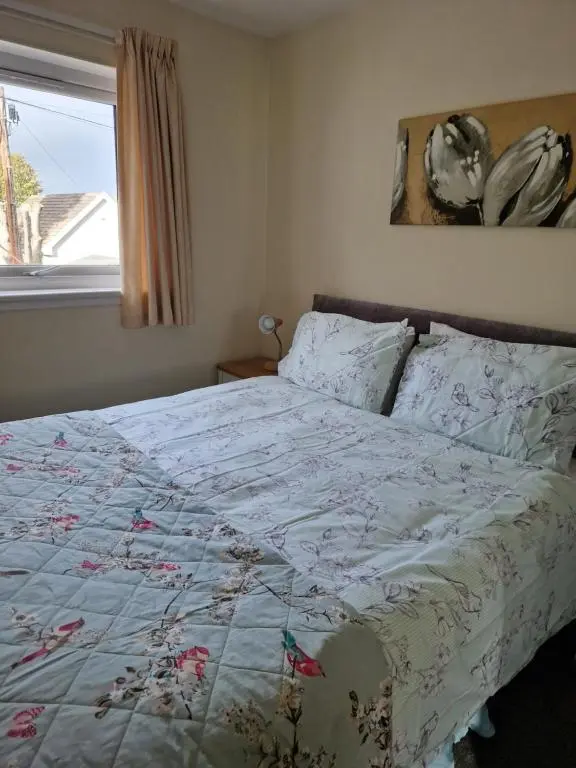 a bedroom with a bed with a quilt on it at No 70G in Inverness