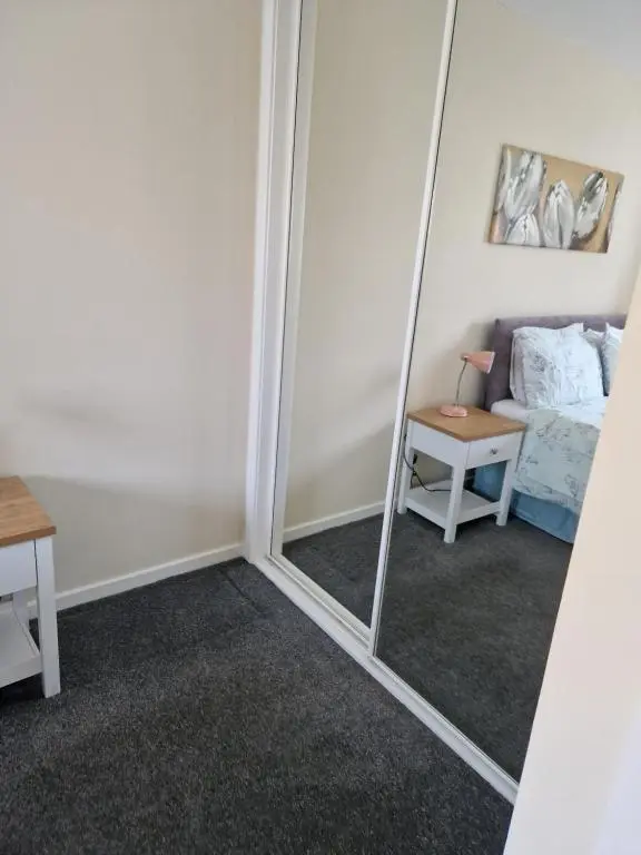 a mirror in a room with a couch at No 70G in Inverness