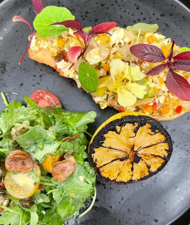 a plate with two slices of pizza and a salad at STAG & THISTLE HOTEL AND RESTAURANT in Fraserburgh