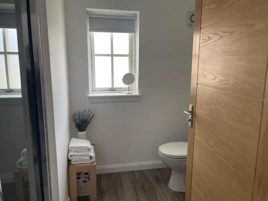 a bathroom with a toilet and a window at 4 Guests - Inverness Highland Hideaway Nc500 in Inverness