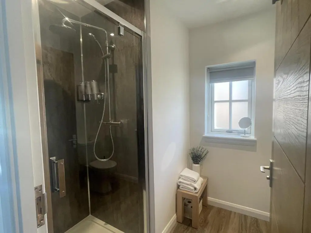 a shower stall in a bathroom with a window at 4 Guests - Inverness Highland Hideaway Nc500 in Inverness