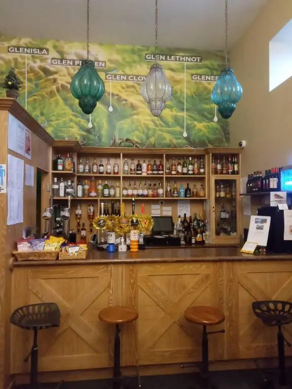 a bar with two stools in front at Glenisla Hotel in Blairgowrie