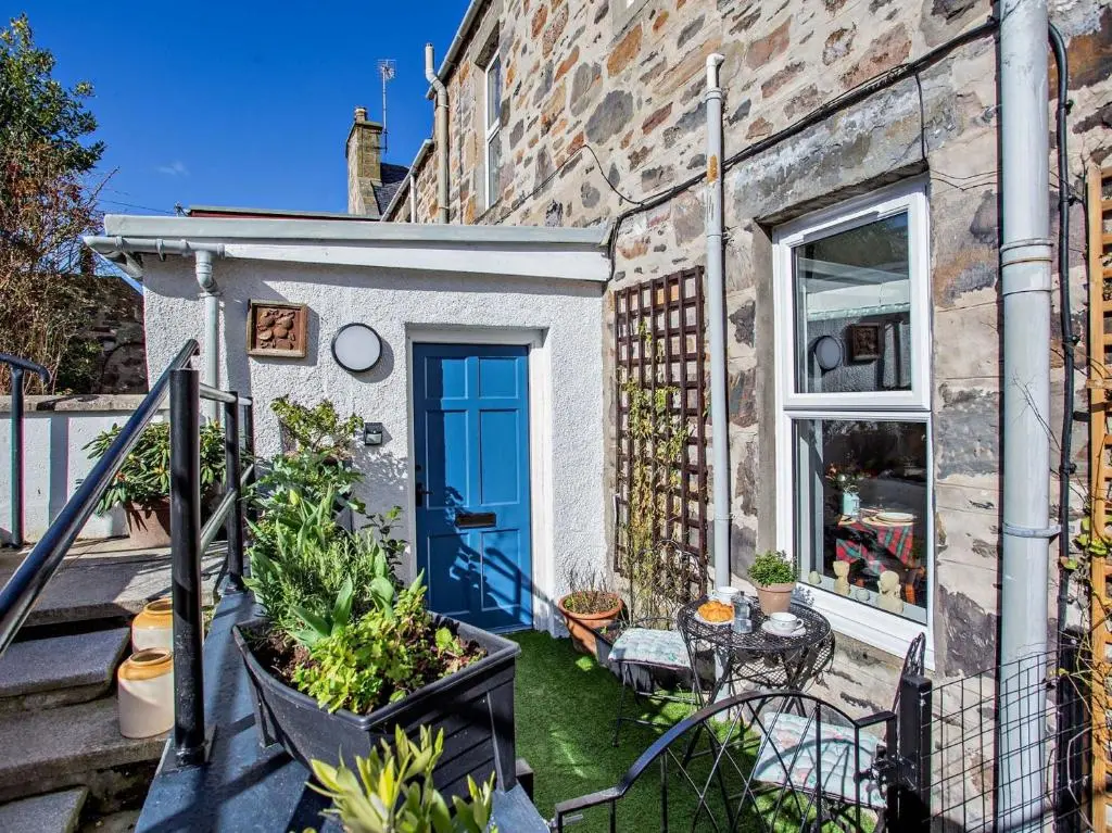 a house with a blue door and some plants at 1 Bed in Cullen 94536 in Cullen
