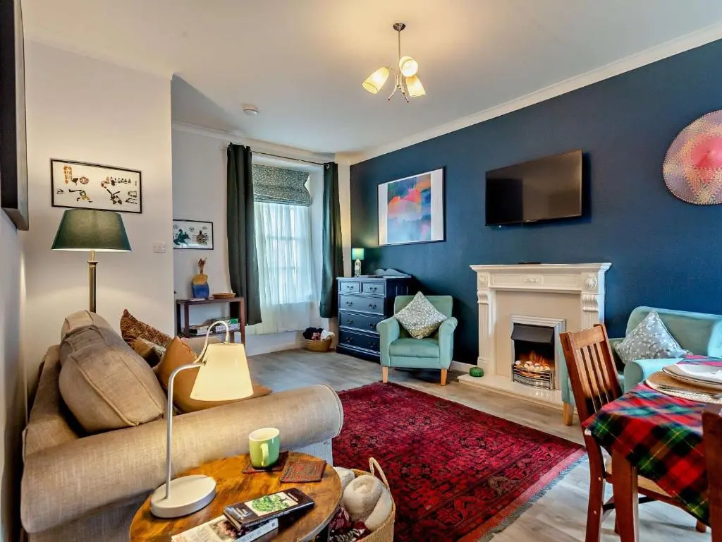 a living room with a couch and a fireplace at 1 Bed in Cullen 94536 in Cullen