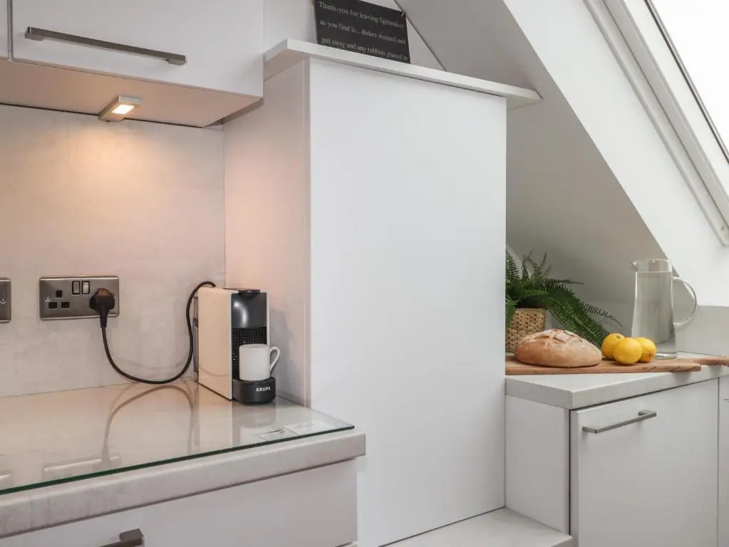 a kitchen with a phone on a counter at Spinnaker in Lossiemouth