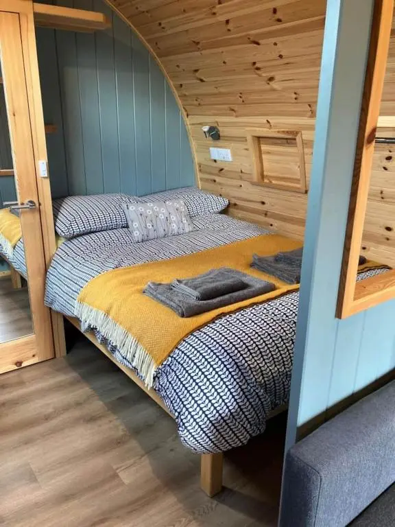 a bedroom with two beds in a cabin at Migdale Pods Luxury Glamping in Bonar Bridge