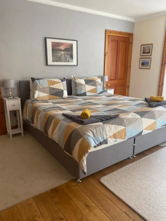 a bedroom with a bed with a fruit on it at The Apartment at Allt-Sagart in Golspie