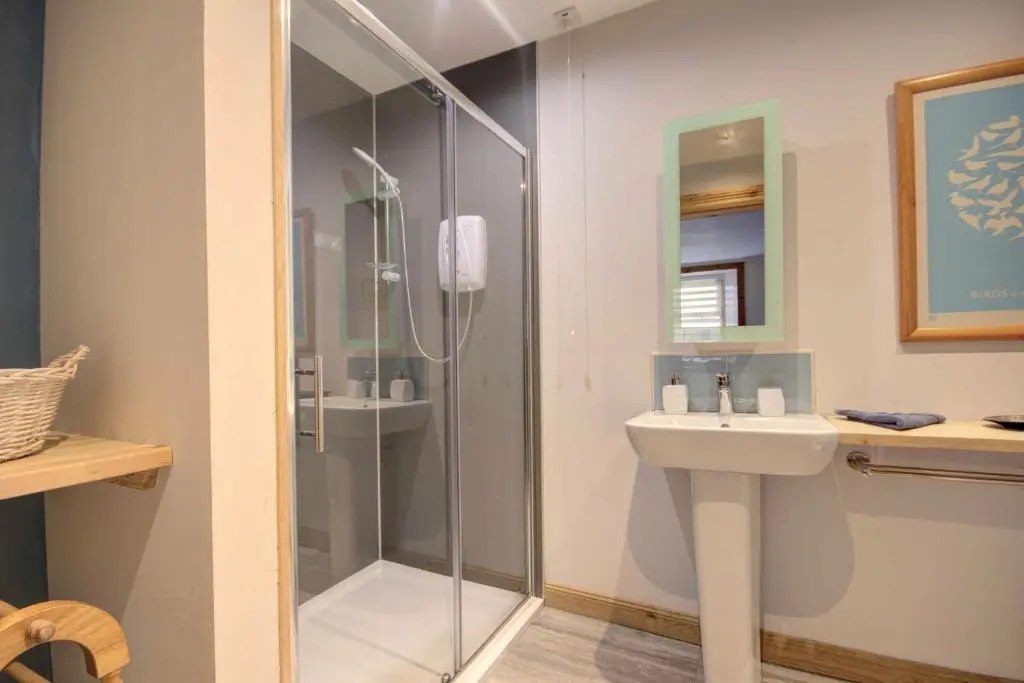a bathroom with a shower and a sink at The Apartment at Allt-Sagart in Golspie