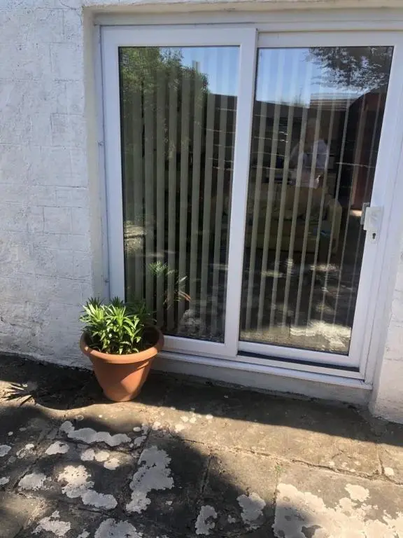 a potted plant sitting in front of a door at Ruthven House Holiday Cottages in Kingussie