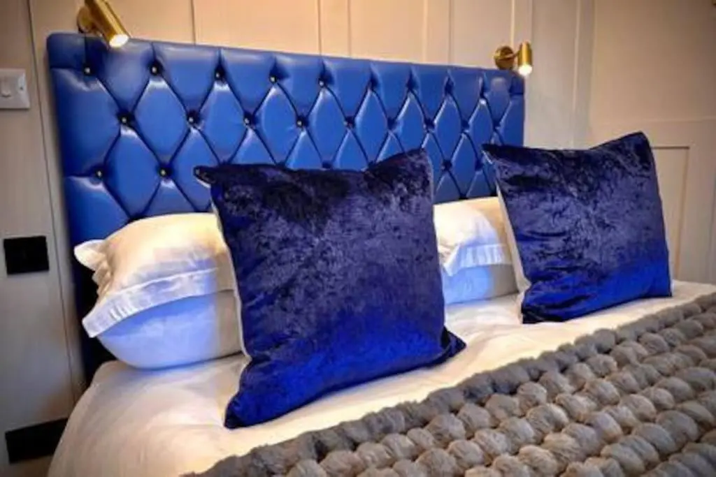 a blue bed with two blue pillows on it at Treat Yourself To Luxury & Style in Inverness