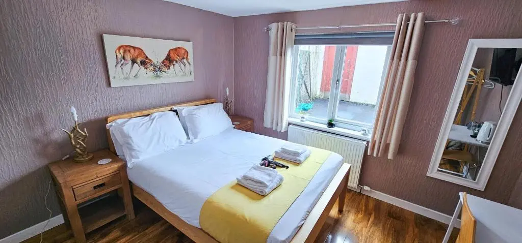 a small bedroom with a bed and a window at Cromarty 4 Bedroom Apartment - Inverness in Inverness