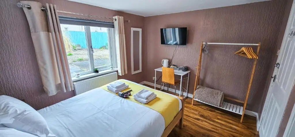a bedroom with a large bed and a window at Cromarty 4 Bedroom Apartment - Inverness in Inverness