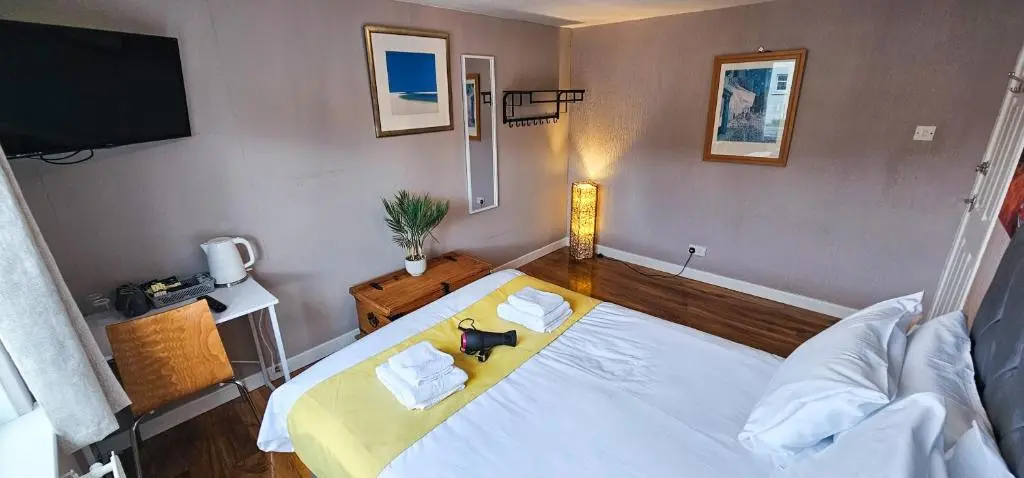 a bedroom with a large white bed and a television at Lovat 2 Bedroom Apartment - Inverness in Inverness