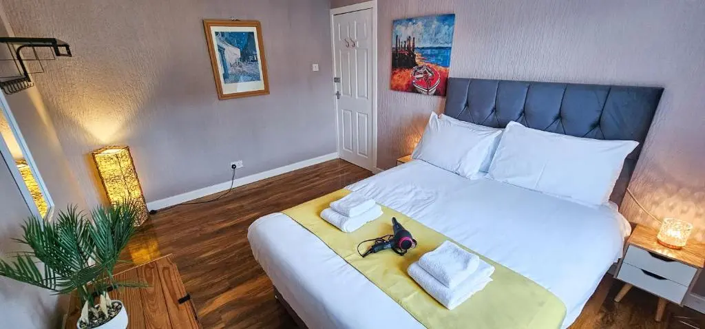 a bedroom with a large white bed with two pillows at Lovat 2 Bedroom Apartment - Inverness in Inverness