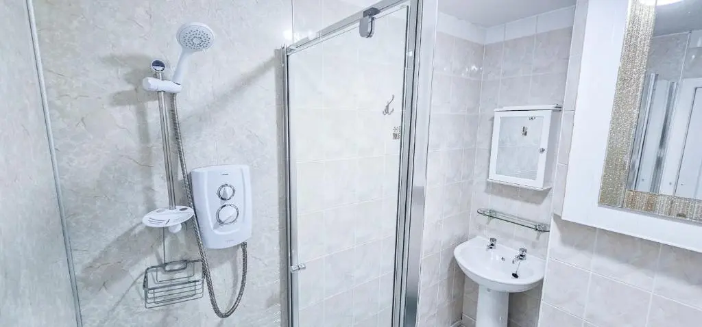 a bathroom with a shower and a sink at Fraser 2 Bedroom Apartment - Inverness in Inverness