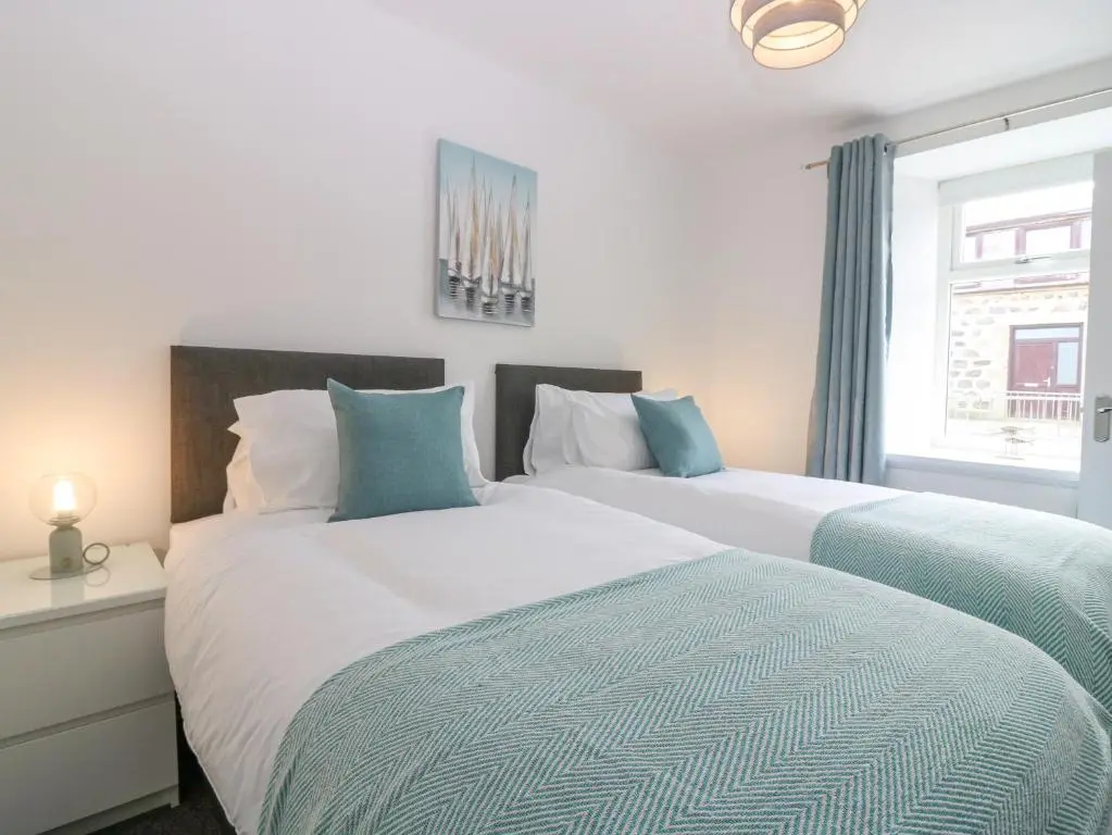 two beds sitting next to each other in a bedroom at 2 College Bounds in Fraserburgh